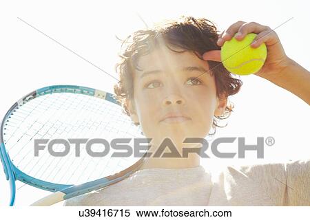 Close up of boy with tennis racket and ball View Large Photo Image Stock Photography - Close up of boy with tennis racket and ball. Fotosearch