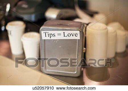 Stock Image - Close up of cafe tip box. Fotosearch