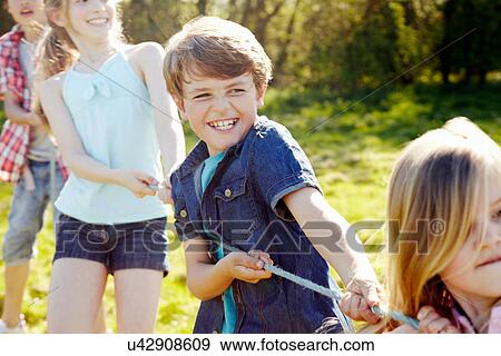 Close up of group of children playing tug o war View Large Photo Image Stock Photo - Close up of group of children playing tug o war. Fotosearch