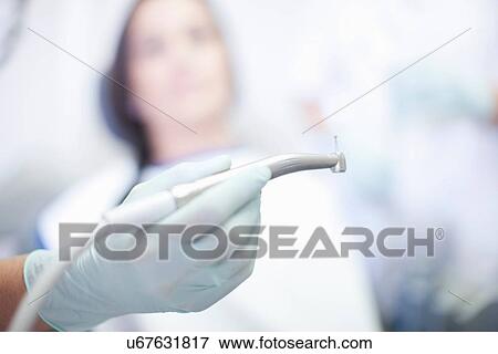 Close up of hand holding dentist drill View Large Photo Image Stock Photo - Close up of hand holding dentist drill. Fotosearch