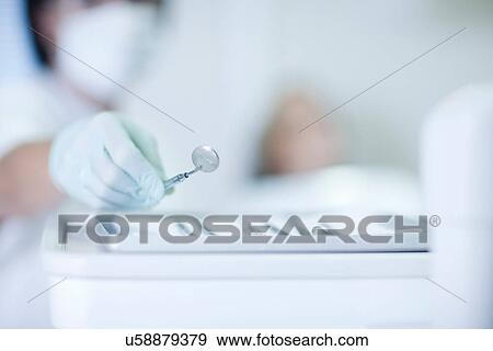 Close up of hand holding dentist mirror View Large Photo Image Stock Photo - Close up of hand holding dentist mirror. Fotosearch