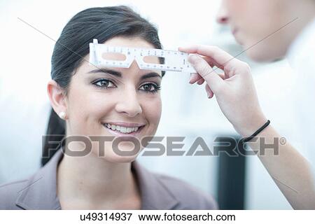 Close up of optician testing patient in eye clinic View Large Photo Image Stock Photo - Close up of optician testing patient in eye clinic. Fotosearch