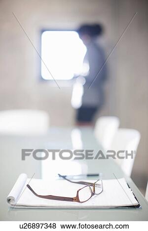 Close up of spectacles and notepad on boardroom table View Large Photo Image Stock Photo - Close up of spectacles and notepad on boardroom table. Fotosearch