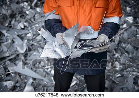 Close up of worker holding scrap aluminum View Large Photo Image Stock Photo - Close up of worker holding scrap aluminum. Fotosearch
