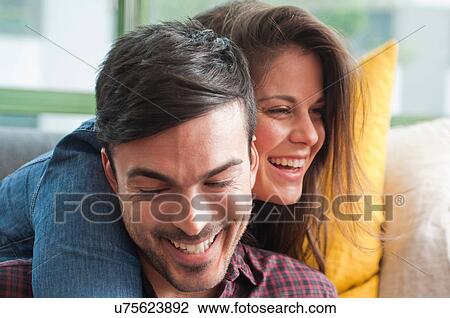 Close up of young couple laughing View Large Photo Image Stock Image - Close up of young couple laughing. Fotosearch