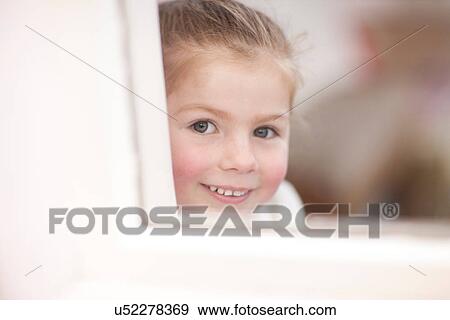Close up of young girl looking through window at ballet class View Large Photo Image Stock Photo - Close up of young girl looking through window at ballet class. Fotosearch