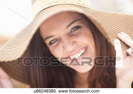 Stock Photography - Close up of young woman in sunhat. Fotosearch