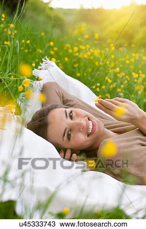 Close up of young woman on picnic blanket with buttercup View Large Photo Image Stock Image - Close up of young woman on picnic blanket with buttercup. Fotosearch