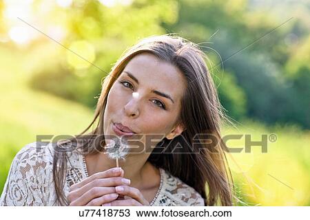 Close up portrait of woman blowing dandelion clock View Large Photo Image Stock Image - Close up portrait of woman blowing dandelion clock. Fotosearch