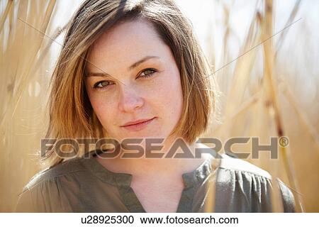 Close up portrait of young woman amongst reeds View Large Photo Image Stock Image - Close up portrait of young woman amongst reeds. Fotosearch