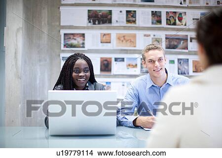 Creative team meeting client in office View Large Photo Image Picture - Creative team meeting client in office. Fotosearch