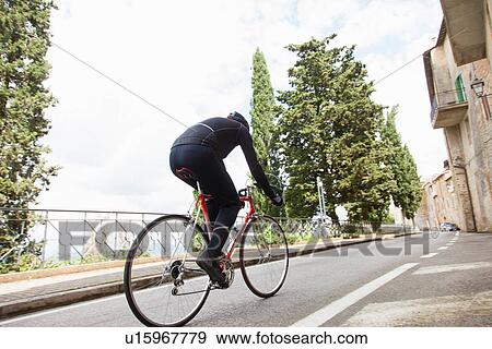 Cyclist riding up road in Umbria, Italy View Large Photo Image Stock Photo - Cyclist riding up road in Umbria, Italy. Fotosearch