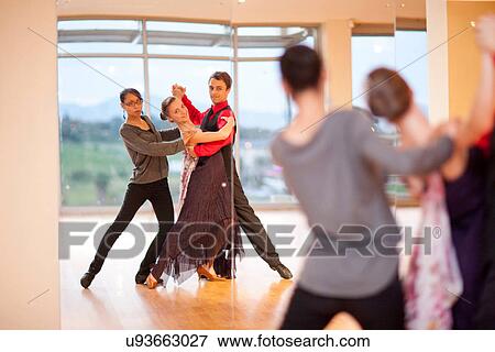 Dance teacher and ballroom dancers looking in mirror View Large Photo Image Stock Photo - Dance teacher and ballroom dancers looking in mirror. Fotosearch