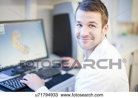 Dental technician using computer to design denture View Large Photo Image Stock Image - Dental technician using computer to design denture. Fotosearch
