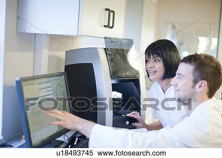 Dental technicians using computer to operate dental equipment View Large Photo Image Stock Photography - Dental technicians using computer to operate dental equipment. Fotosearch