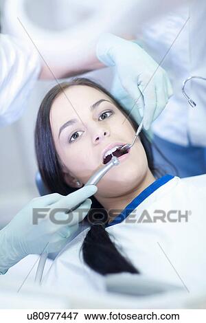 Dentist drilling patients teeth View Large Photo Image Stock Photo - Dentist drilling patients teeth. Fotosearch