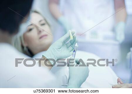 Dentist holding syringe View Large Photo Image Stock Image - Dentist holding syringe. Fotosearch