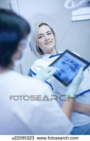 Dentist using touch screen on digital tablet View Large Photo Image Stock Image - Dentist using touch screen on digital tablet. Fotosearch