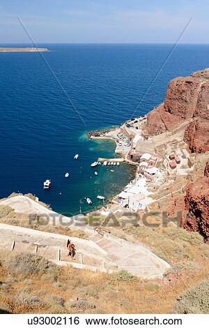 Distant view of female tourist walking down steps, Oia, Santorini, Greece View Large Photo Image Stock Photograph - Distant view of female tourist walking down steps, Oia, Santorini, Greece. Fotosearch
