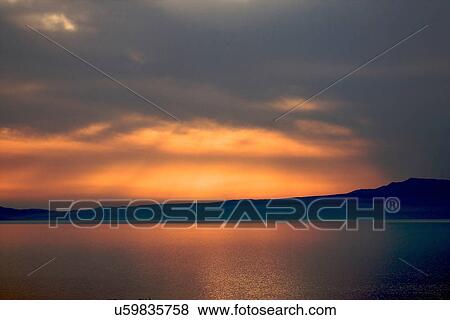 Stock Photo - Dramatic sunset Stoupa, the Mani region in Greece. Fotosearch