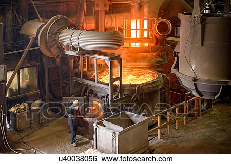 Stock Photograph - Elevated view of steel worker and furnace in steel foundry. Fotosearch