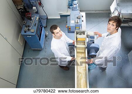Elevated view of two scientists in technical laboratory View Large Photo Image Stock Image - Elevated view of two scientists in technical laboratory. Fotosearch
