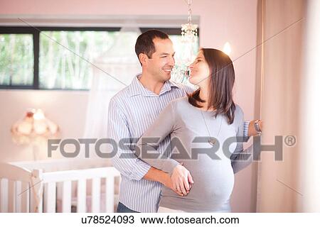 Expectant couple in nursery View Large Photo Image Stock Image - Expectant couple in nursery. Fotosearch