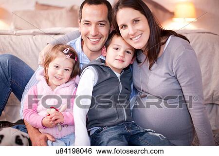 Expectant couple with two young children View Large Photo Image Stock Photograph - Expectant couple with two young children. Fotosearch