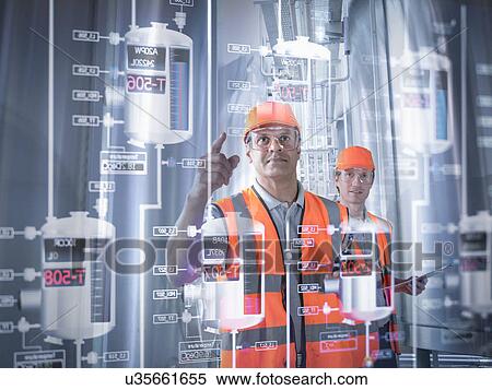 Factory supervisor monitoring product levels on interactive screen View Large Photo Image Stock Photography - Factory supervisor monitoring product levels on interactive screen. Fotosearch