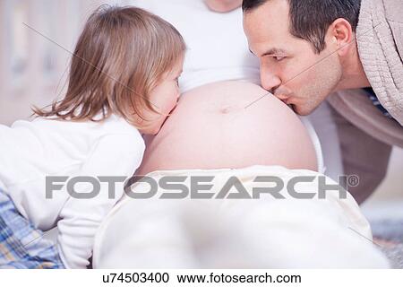 Father and daughter kissing mothers bump View Large Photo Image Stock Image - Father and daughter kissing mothers bump. Fotosearch