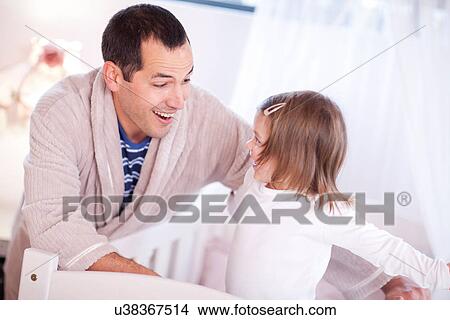 Father playing with young daughter in cot View Large Photo Image Picture - Father playing with young daughter in cot. Fotosearch