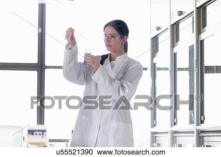 Female scientist holding sample and pipette View Large Photo Image Stock Image - Female scientist holding sample and pipette. Fotosearch