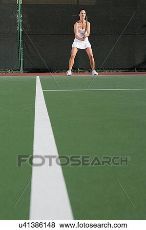 Female tennis player on court awaiting serve View Large Photo Image Stock Photo - Female tennis player on court awaiting serve. Fotosearch