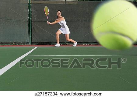 Picture - Female tennis player ready to return serve. Fotosearch