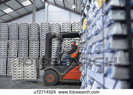 Picture - Forklift truck moving stock in warehouse. Fotosearch