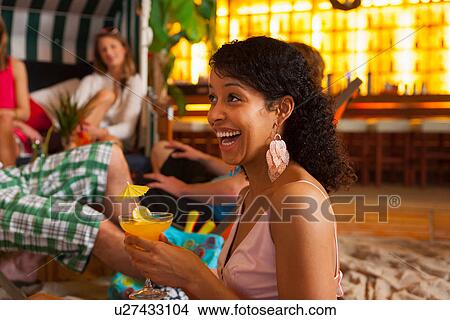 Friends enjoying cocktails in bar View Large Photo Image Picture - Friends enjoying cocktails in bar. Fotosearch