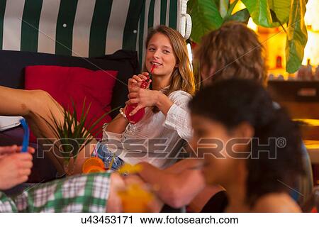 Stock Image - Friends enjoying drinks at party. Fotosearch