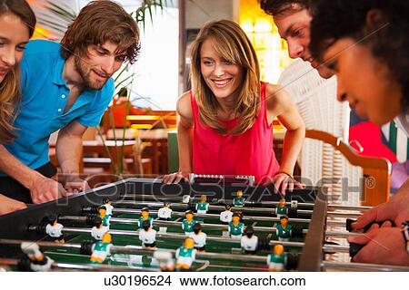 Friends playing table football View Large Photo Image Picture - Friends playing table football. Fotosearch