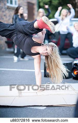 Stock Photograph - Girl breakdancing in carpark. Fotosearch