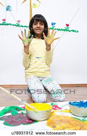 Girl kneeling on floor finger painting View Large Photo Image Stock Image - Girl kneeling on floor finger painting. Fotosearch