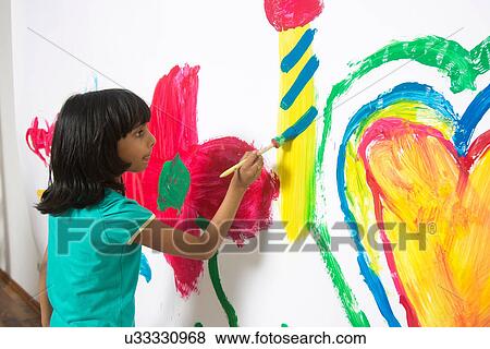Girl painting playroom wall View Large Photo Image Stock Photo - Girl painting playroom wall. Fotosearch