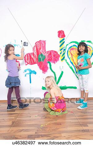Girls painting wall View Large Photo Image Stock Photo - Girls painting wall. Fotosearch