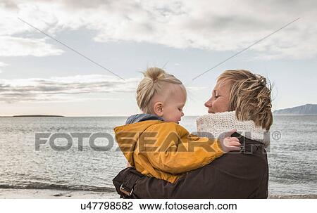 Grandmother and toddler hugging at coast View Large Photo Image Stock Image - Grandmother and toddler hugging at coast. Fotosearch