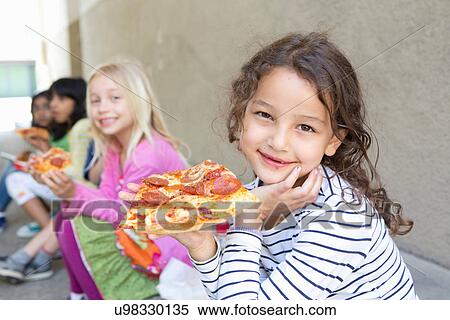 Group of children eating pizza outdoors View Large Photo Image Stock Photography - Group of children eating pizza outdoors. Fotosearch