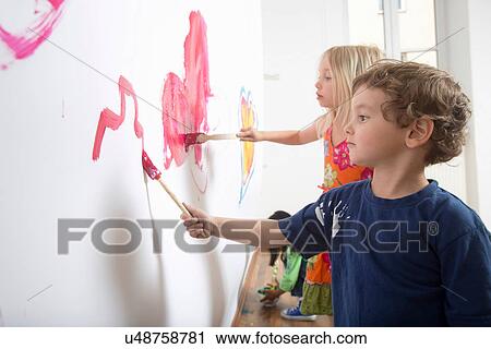 Group of children painting wall View Large Photo Image Stock Image - Group of children painting wall. Fotosearch