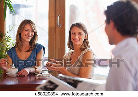 Group of friends chatting in cafe bar View Large Photo Image Picture - Group of friends chatting in cafe bar. Fotosearch
