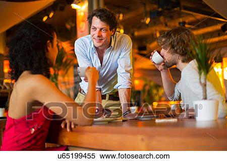 Group of friends chatting in cafe View Large Photo Image Stock Photography - Group of friends chatting in cafe. Fotosearch