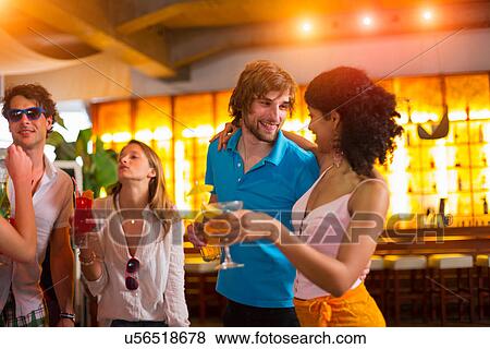 Group of friends with cocktails in bar View Large Photo Image Stock Photo - Group of friends with cocktails in bar. Fotosearch
