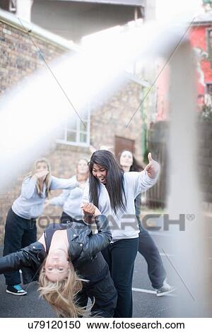 Group of girls dancing in playground View Large Photo Image Stock Image - Group of girls dancing in playground. Fotosearch