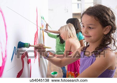 Group of girls painting wall View Large Photo Image Stock Photo - Group of girls painting wall. Fotosearch